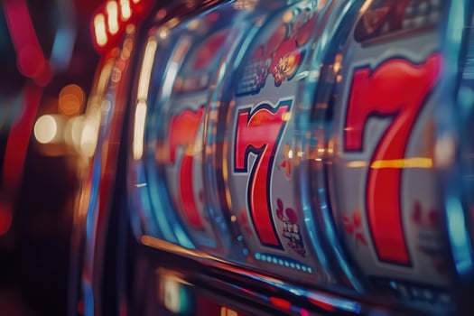 three red sevens on slot machine. close-up of casino winnings on slot machine with blurred background. concept of casino and gambling addiction photo