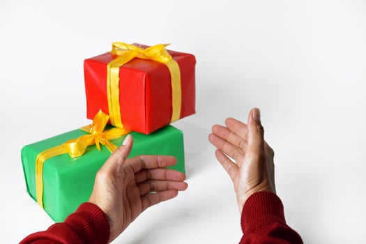 Sweater-Clad Hands Offering a Present photo