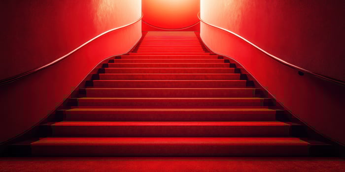 Staircase illuminated by a bright red light creates a striking visual contrast and a sense of mystery in a contemporary setting photo