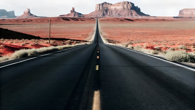 A long road to the mountains in the desert photo