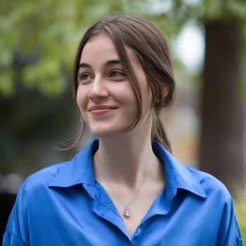 A woman in a blue shirt smiling photo