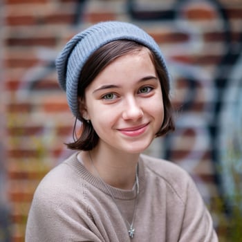 A young girl wearing a beanie and a sweater photo