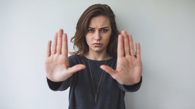 A woman making a stop sign with her hands photo