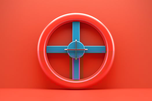 A vibrant red circular target with a contrasting blue crosshair, set against a solid red background. photo