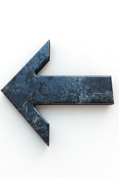 Stylized black stone arrow pointing left, perfect for directional signage in modern decor. photo