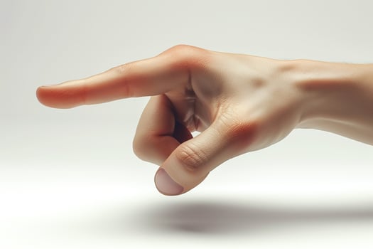 A close-up of a Caucasian male hand pointing with a relaxed posture against a soft, neutral backdrop. photo