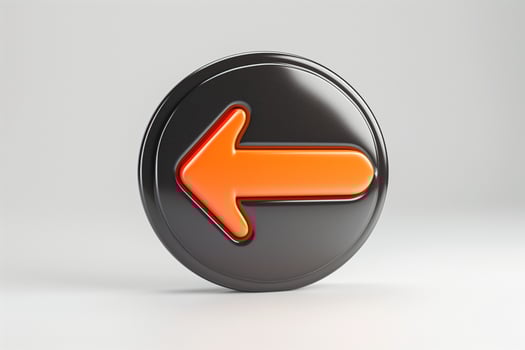 A bold, black circular button featuring a prominent orange left arrow, symbolizing direction and navigation. photo