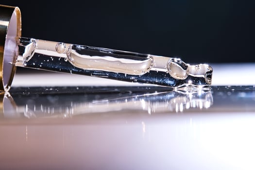 A serum pipette on a dark background. photo