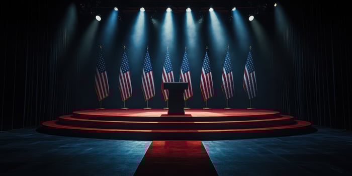 Dramatic stage setup with American flags and podium at night before a significant political event photo