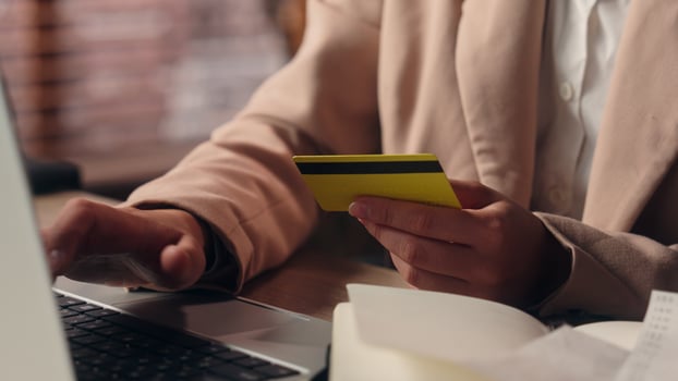 Close up unknown confused Caucasian business woman girl female businesswoman lady customer client try pay online holding credit card enter password laptop error mistake scam bank fail payment indoors photo