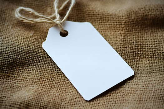 Blank Price Tag on Burlap Fabric photo