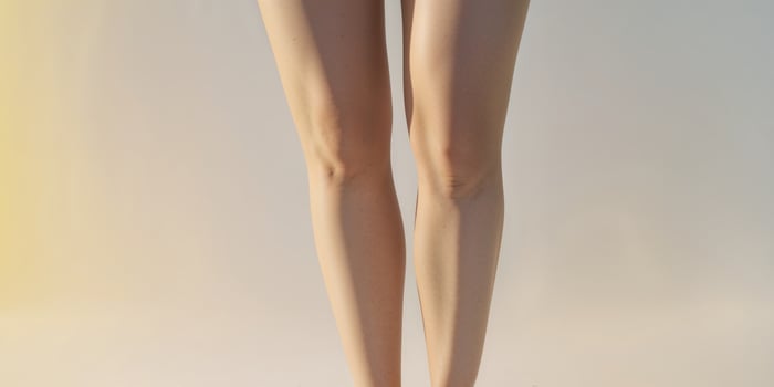 Smooth female thighs with soft skin and glowing background photo