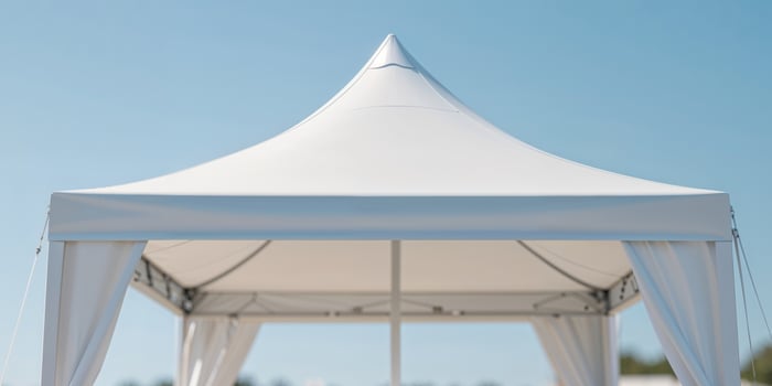 White canopy tent with table for outdoor events or market stall photo