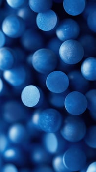 Blue circular beads arranged closely together create a textured background effect in a vibrant display photo