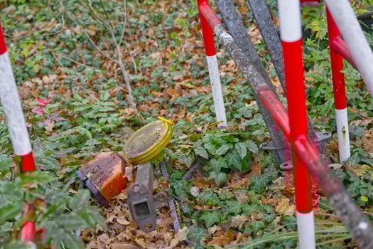 Cluttered Outdoor Scene with Construction Barriers and Leaves photo