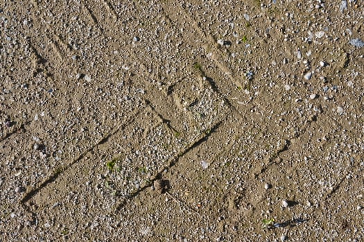 Textured Sandy Ground with Tire Tracks photo