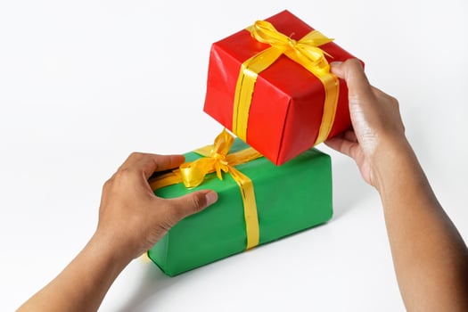 A Mans Hands Presenting Multiple Festive Packages photo