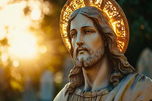 Ancient statue of Jesus Christ with golden halo during sunset photo