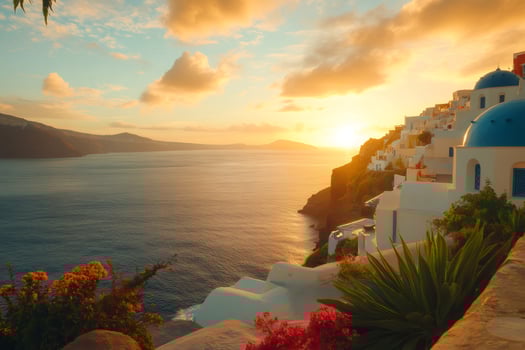 Golden sunset illuminating white houses and blue domed churches of Oia, Santorini, Greece. photo