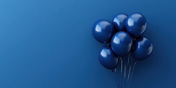 Blue balloons float together against a solid blue background in a simple and elegant display photo
