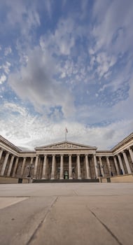 Neoclassical facade of the British Museum in London, with its symmetrical columns, emphasizes the museum historic legacy under an open sky. photo