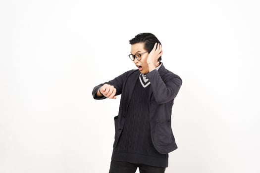 A man in glasses and a sweater is holding his hand to his ear photo