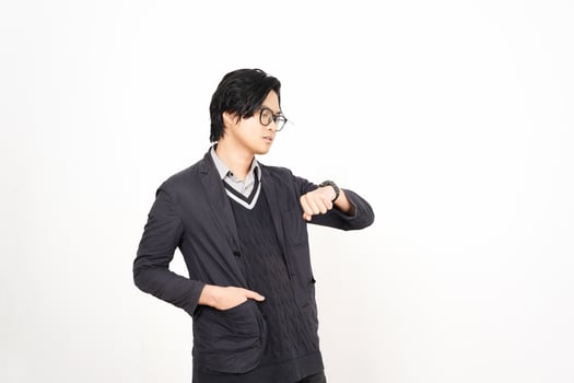 A man in glasses and a jacket is standing in front of a white background photo