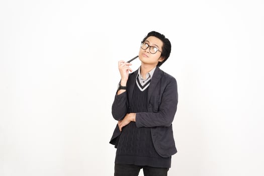 A man in glasses and a sweater is standing with his hand on his chin photo