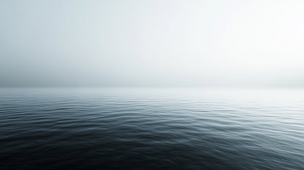 Serene ocean vista with subtle ripples under a misty sky, evoking calm and tranquility. The horizon is barely visible in the soft light. photo