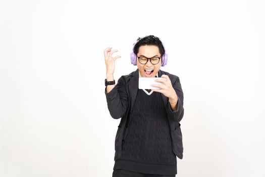 A man in headphones holding a phone and smiling photo