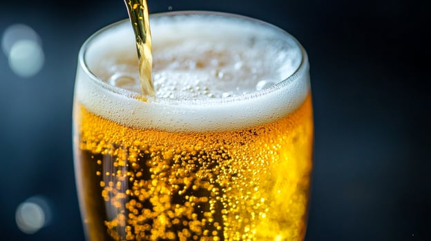Refreshing glass of golden liquid being poured with frothy head. Close-up shot capturing the sparkling bubbles and inviting color. photo