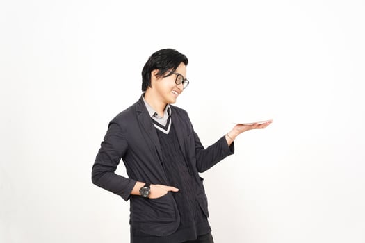 Asian man in suit holding something out photo