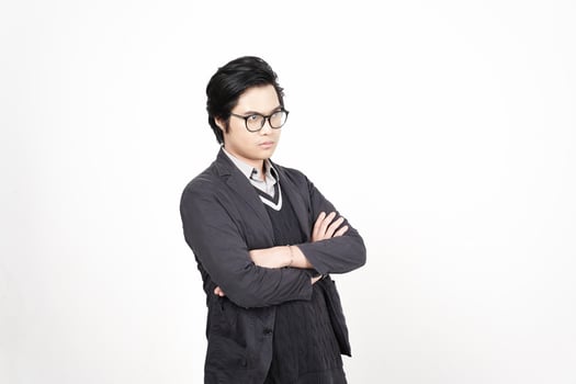 A man in glasses and a jacket standing with his arms crossed photo