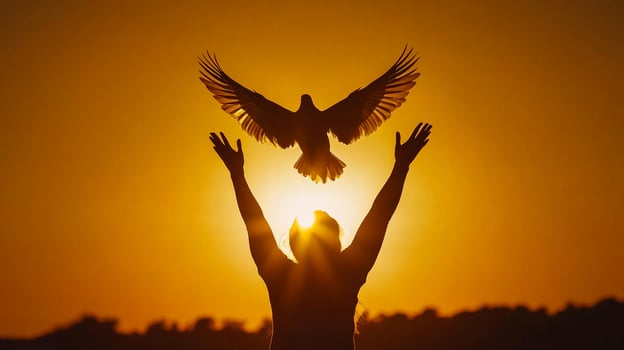 Person releasing a dove into the sunset symbolizing freedom, peace, and hope. Uplifting imagery with an orange backdrop. photo
