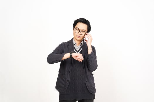 A man in glasses and a sweater is holding his wrist watch photo