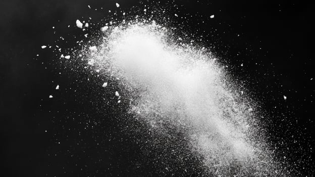 Scattered white powder against a stark black background. An artistic composition featuring contrasting colors and textures. Minimalist and clean. photo