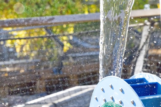 Water Flowing from Hose Reel in Sunlight photo