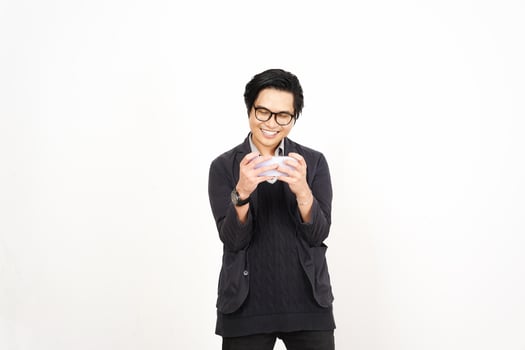 A man in glasses holding a white object photo
