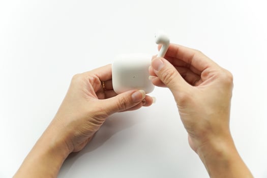 A person holding a white object in their hand photo
