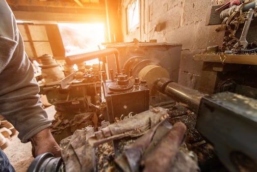 Elderly Craftsman Working in a Rustic Workshop photo