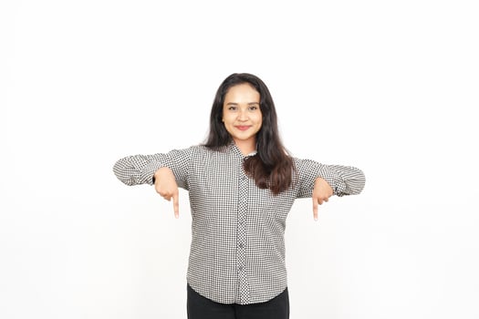 A woman in a shirt and pants is pointing at something photo