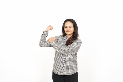 A woman flexing her arms in front of a white background photo