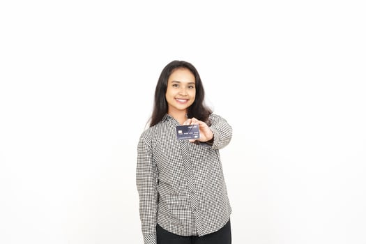 A woman holding a credit card in front of her photo