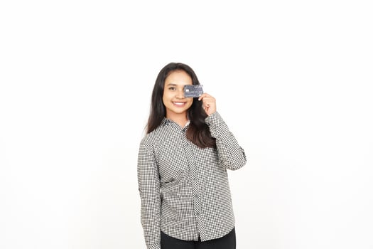 A woman holding a credit card in front of her face photo