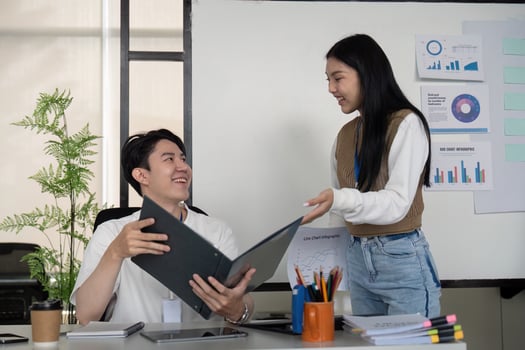 Young professionals reviewing financial reports and collaborating on strategies in a modern office. photo