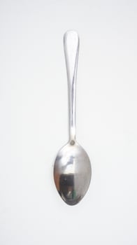 Top view of stainless steel spoon isolated on white background photo