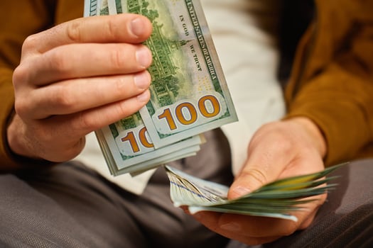 Man counting US dollar banknotes, close up. Cash savings photo