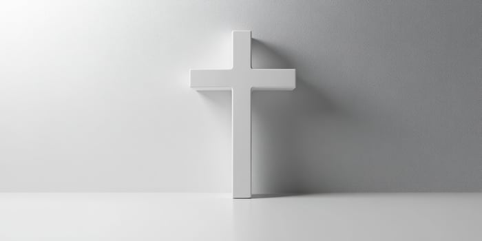 White cross standing against a minimalistic gray background highlighting simplicity and spirituality in modern design photo