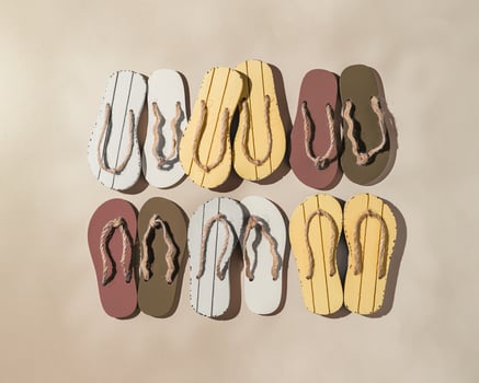 Female summer shoes, set sandals as creative square pattern with hard shadow, beige brown white flip flops on beige gradient background. Aesthetic trend summer fashion concept, life style photo