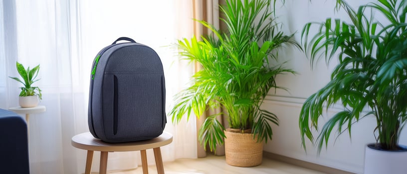 Dark Backpack on Stool in Room photo